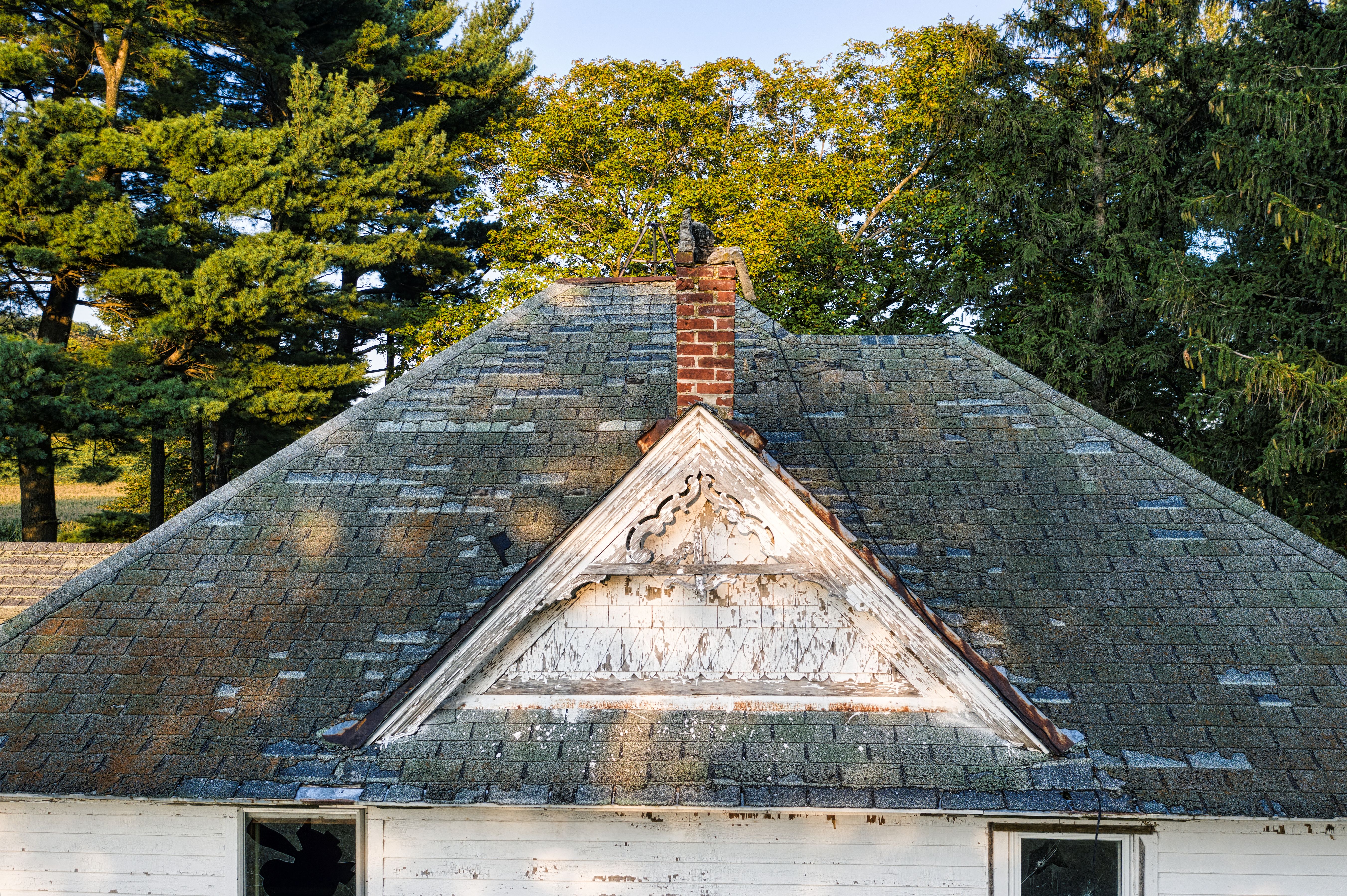 Worn and weathered asphalt shingles nearing the end of their lifespan
